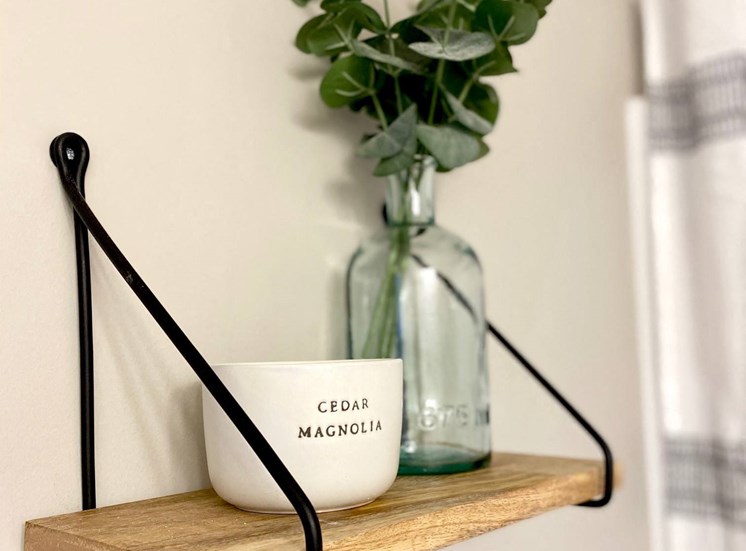 Bathroom shelf magnolia candle eucalyptus in blue glass jar